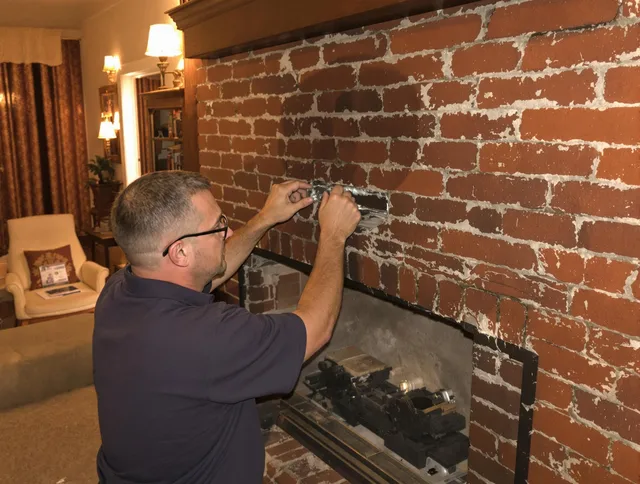 South Euclid Chimney Sweep expert fixing a fireplace in South Euclid, OH